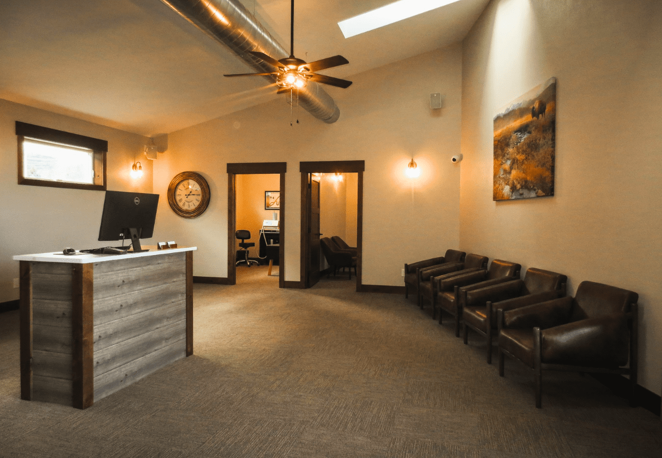 Whitewood Creek Chiropractic new lobby with receptionist desk and leather chairs
